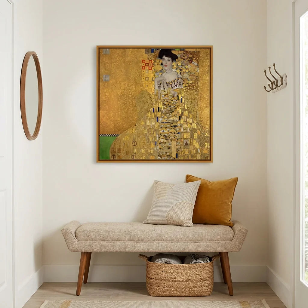 Gustav Klimt's Portrait of Adele Bloch-Bauer I, the iconic gold Art Nouveau painting, framed above a bench in a warm entryway