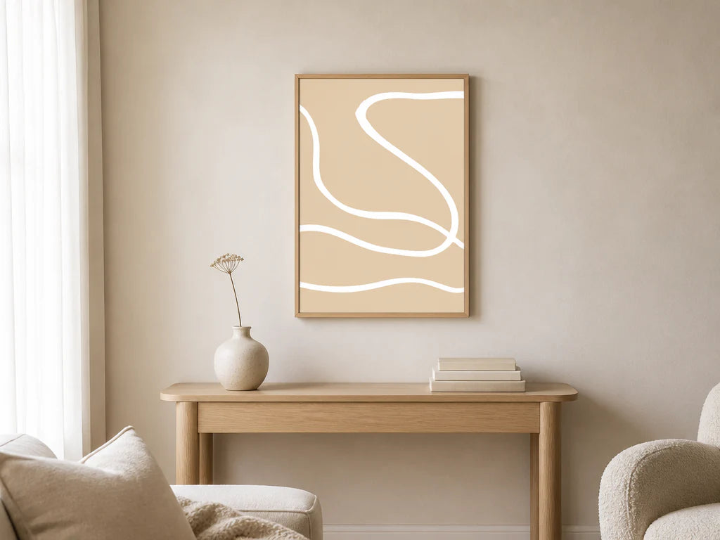 Minimalist beige line-art print framed in oak, centred above a pale oak console in a warm neutral living room