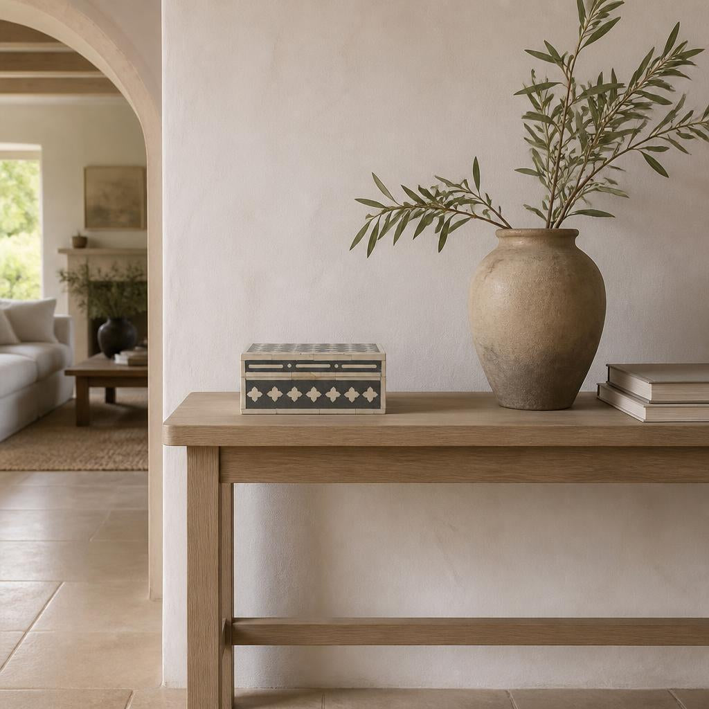 Bone inlay box on a pale oak console in a limewashed entrance hall