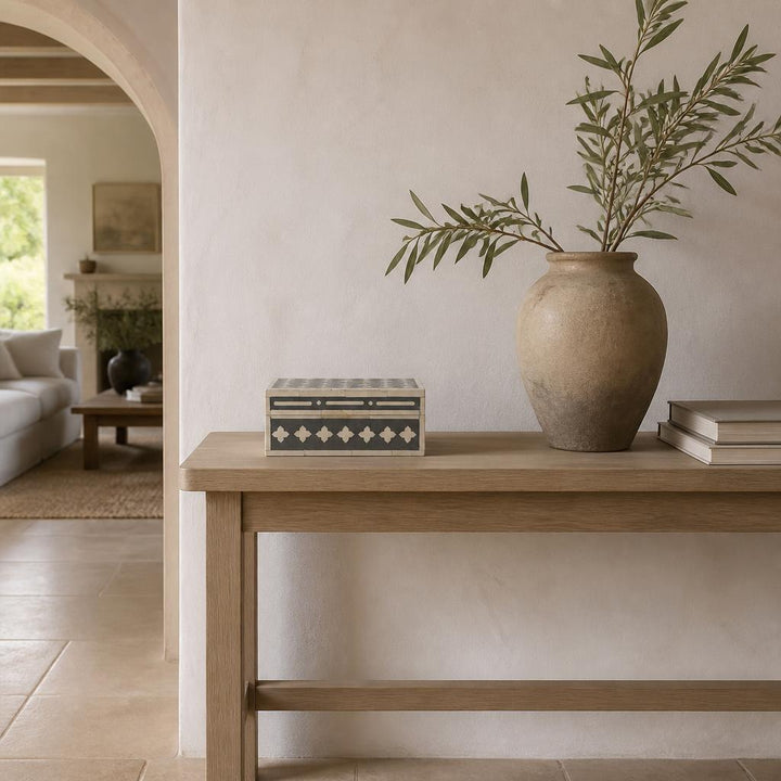 Bone inlay box on a pale oak console in a limewashed entrance hall